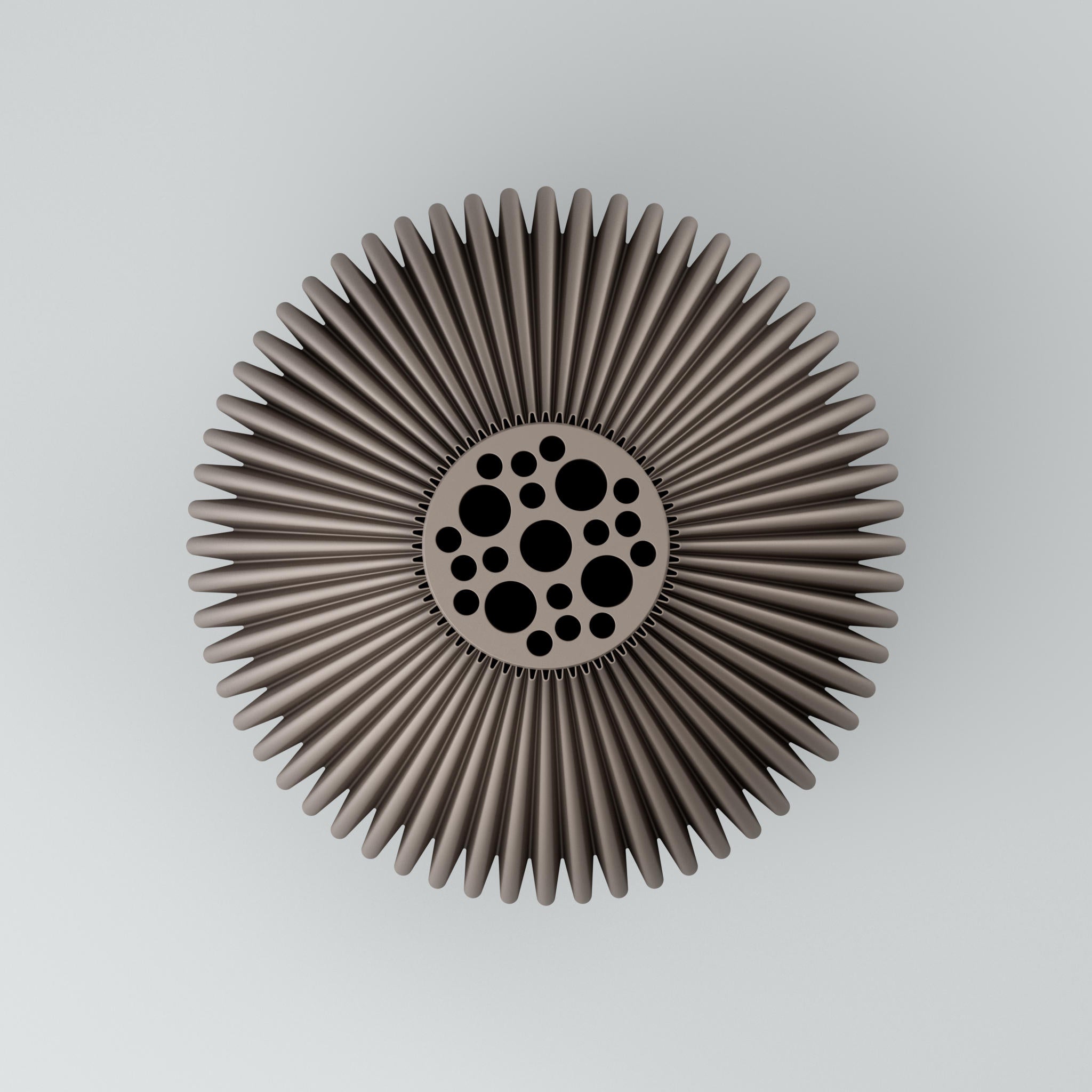Metallisches sternförmiges Rad mit Rippen und Kreisornament aus schwarzen Punkten vor hellem Hintergrund.