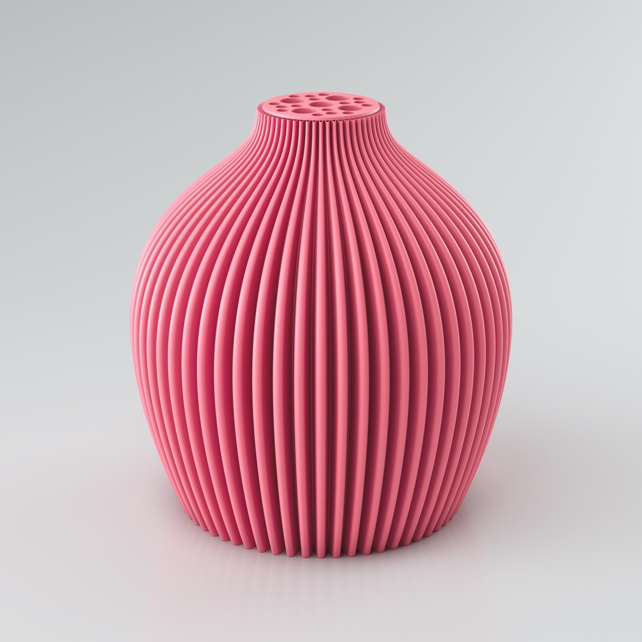Eine moderne, modulare Designvase namens Voravellie 60 von Blooming3D in einem sanften Beigeton. Die Vase hat eine skulpturale Form mit einer ausgeprägten, präzise ausgearbeiteten Rippstruktur, die für ein faszinierendes Licht- und Schattenspiel sorgt. Am oberen Ende befindet sich ein integrierter Blumenretter mit unterschiedlich großen runden Öffnungen, ideal für stilvolle Trockenblumenarrangements. Die klaren Kanten und die dynamische Form vereinen Architektur und Design in einem Objekt. Die Vase...